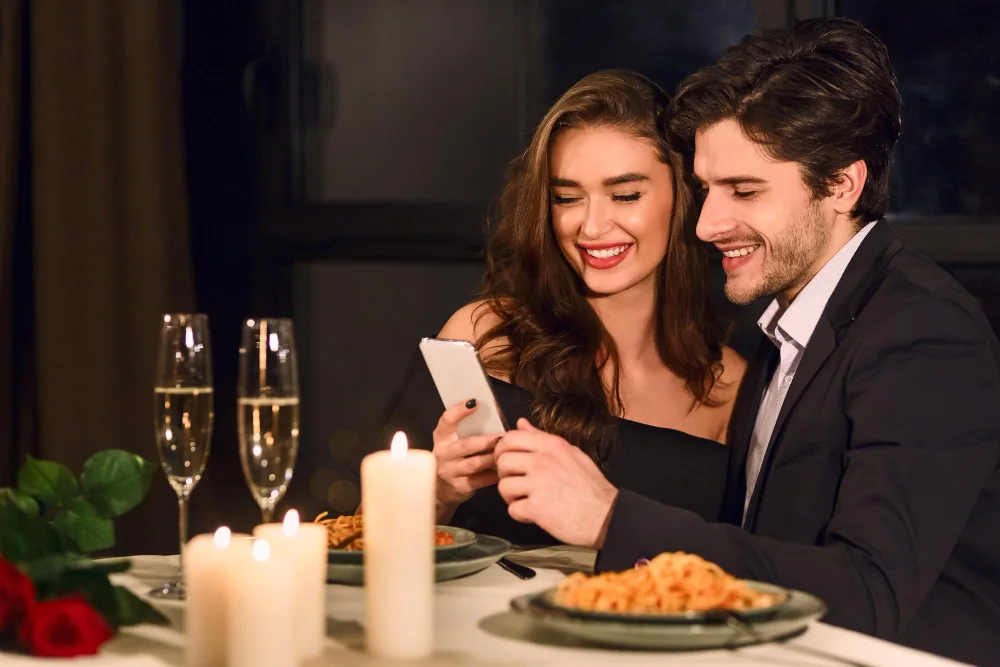 Adult couple reviewing a message together during dinner